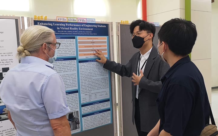 Presenting the poster at ISNST 2022 to an attendee at the poster session.